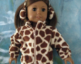 May include: A doll wearing a giraffe-print jacket and matching earmuffs. The jacket is brown and white with a full zipper. The doll is also wearing white pants. The background is a blue and white abstract design.