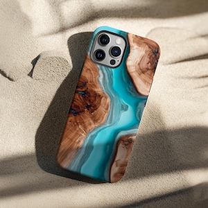 May include: A smartphone case featuring a design that mimics natural wood grain with swirling patterns of light and dark brown, intersected by a vibrant, flowing river of bright turquoise blue resin that runs diagonally across the back surface.