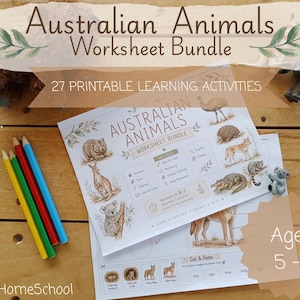 May include: A bundle of Australian Animals worksheets with the title "Australian Animals Worksheet Bundle" and the text "27 Printable Learning Activities". The worksheets feature illustrations of Australian animals and are designed for ages 5-7. Colored pencils are also visible.