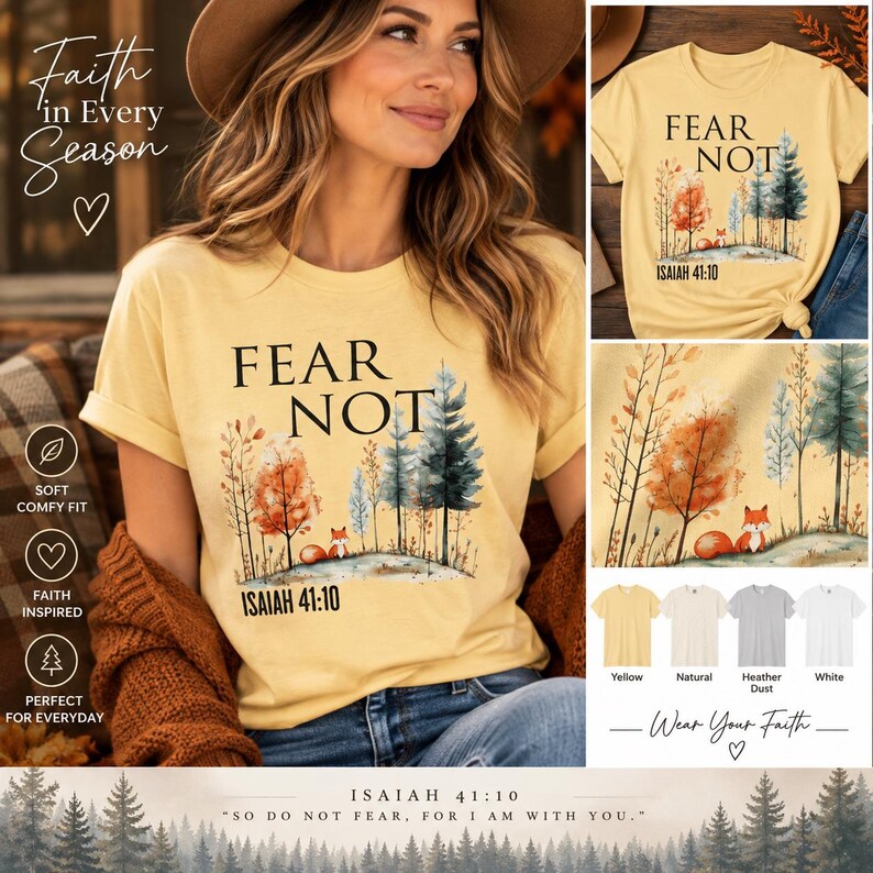 May include: A pale yellow t-shirt featuring a graphic of a forest with a small fox, the text FEAR NOT, and the scripture reference ISAIAH 41:10. The design includes watercolor-style trees in shades of orange, green, and blue on a light background.