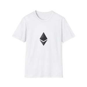 May include: White t-shirt with a black and grey Ethereum logo. The logo is a diamond shape with a smaller diamond inside. The shirt has short sleeves and a crew neck.