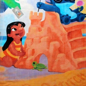 May include: Beach towel featuring a colorful illustration of Lilo and Stitch at the beach. Stitch wears sunglasses and holds a flag and ice cream. Lilo is building a sandcastle. The words "Lilo" and "Stitch" are written in the sand.