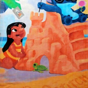 May include: Beach towel featuring a colorful illustration of Lilo and Stitch at the beach. Stitch wears sunglasses and holds a flag and ice cream. Lilo is building a sandcastle. The words "Lilo" and "Stitch" are written in the sand.