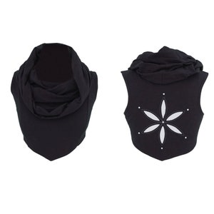 May include: Black sleeveless hooded top with a white flower design on the back.
