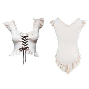 May include: A white sleeveless top with a lace-up front and a ruffled neckline and hem.