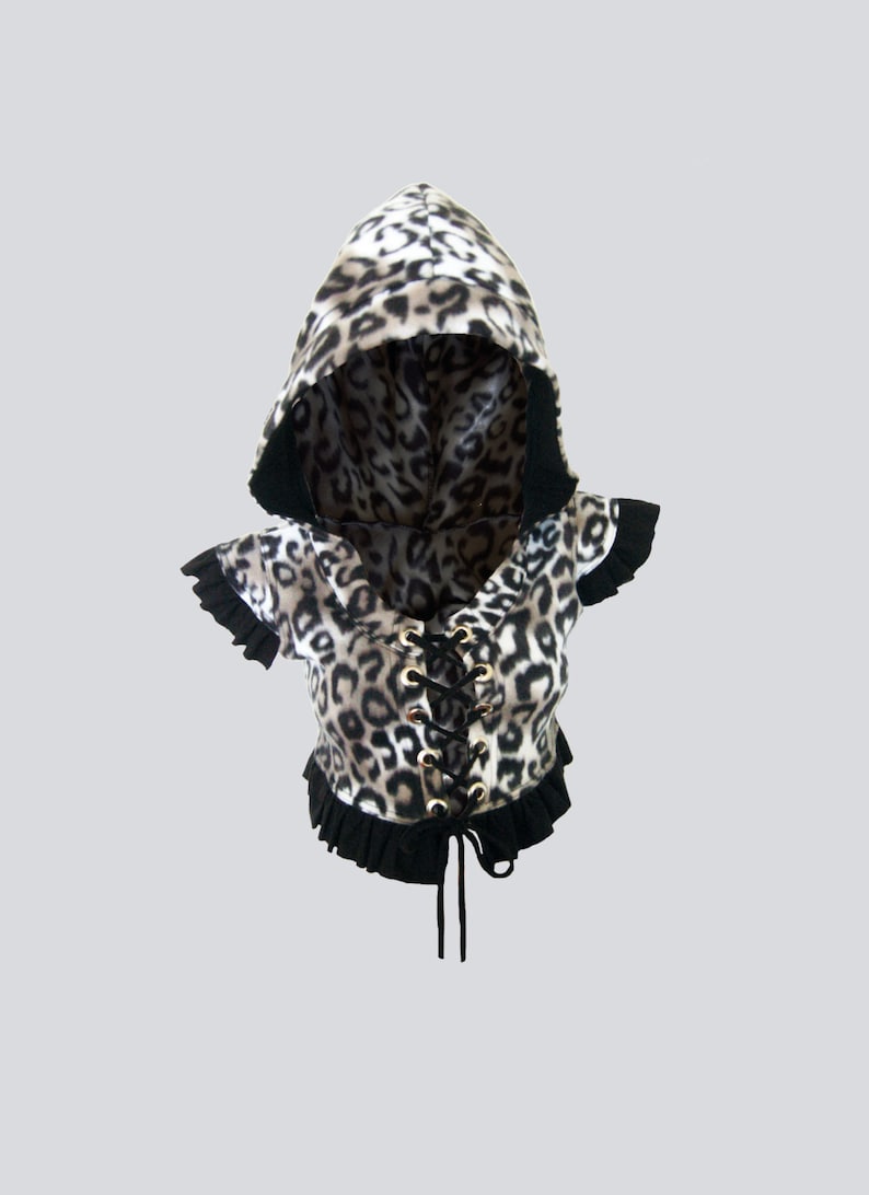 May include: A black and white leopard print hooded top with a black lace-up front and black ruffle trim.