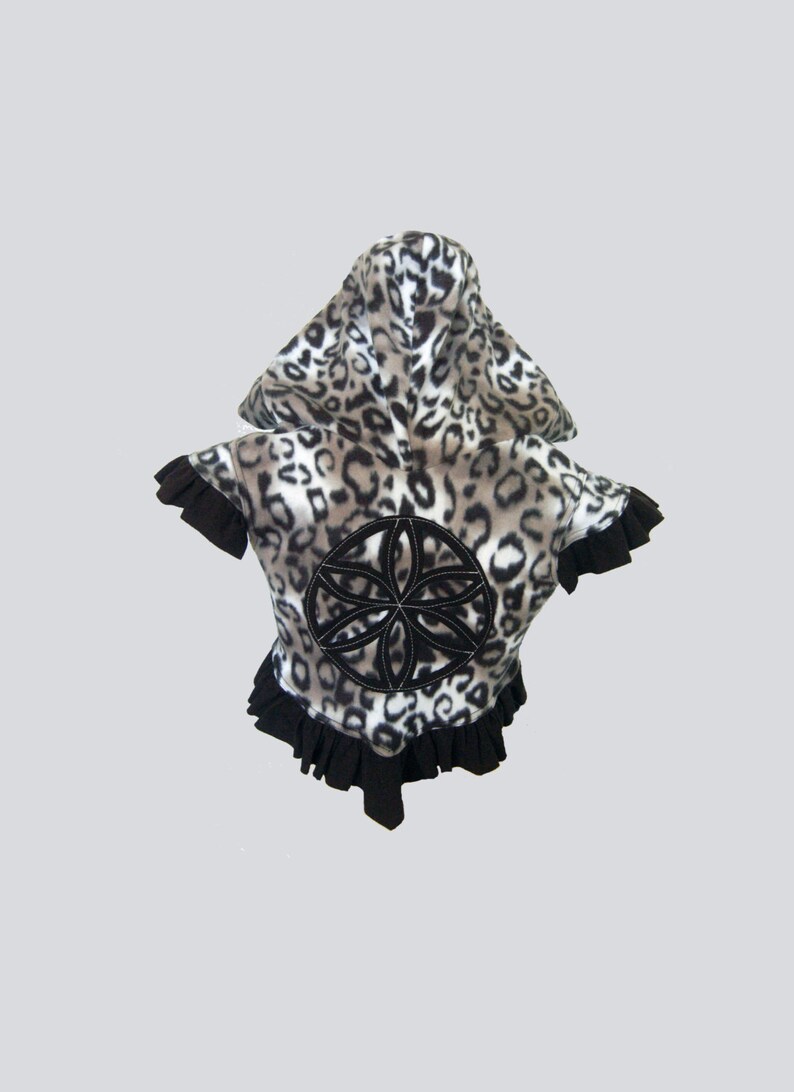 May include: A black and white leopard print hooded jacket with a black ruffle trim and a black embroidered flower design on the back.