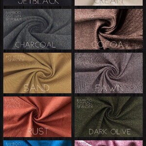 May include: A collection of fabric swatches in various colours, including jet black, charcoal, sand, rust, ocean, cream, cocoa, fawn, dark olive, and dusty rose. Each swatch is labelled with the fabric composition and colour name.