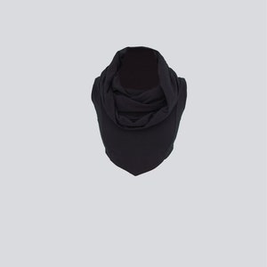 May include: A black cowl neck scarf made of a soft, stretchy fabric.