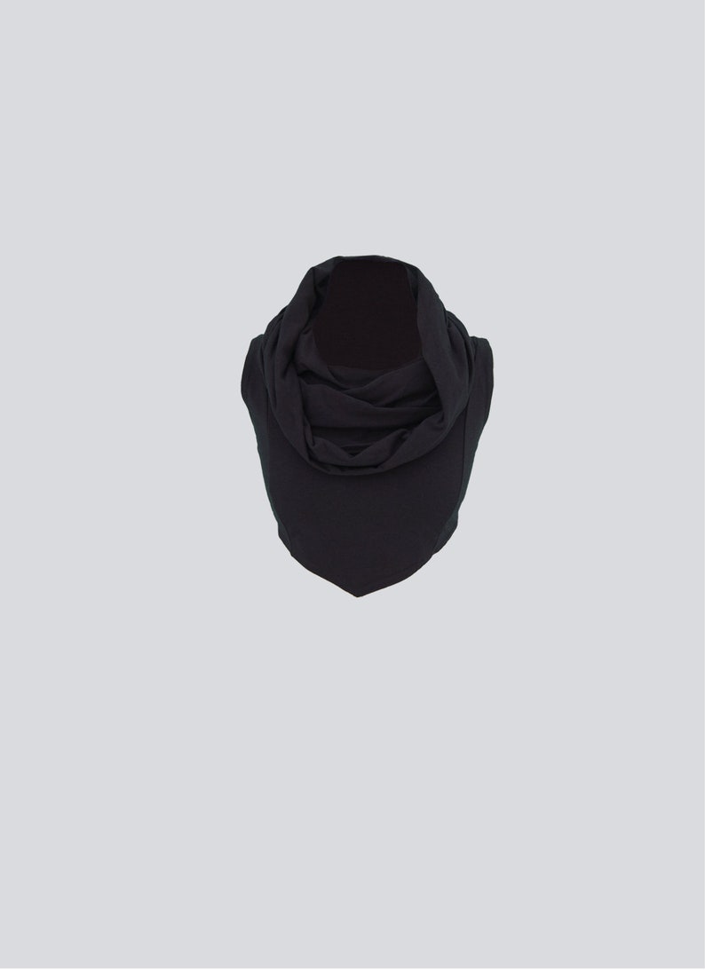 May include: A black cowl neck scarf made of a soft, stretchy fabric.