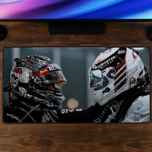 May include: A rectangular desk mat featuring a high-resolution graphic of two race car drivers wearing helmets facing each other. The left helmet is black with red and white accents, while the right helmet is white with red and black details.