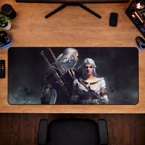 May include: A rectangular gaming mouse pad featuring a detailed illustration of two characters with white hair, swords, and armor, set against a dark, atmospheric background. The pad is black with a smooth surface, designed for optimal mouse performance.