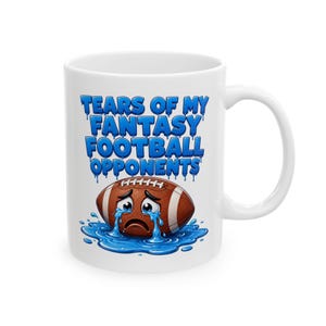 May include: White ceramic mug with a handle featuring the text "TEARS OF MY FANTASY FOOTBALL OPPONENTS" in blue dripping font. A cartoon football with a sad face is in a puddle of blue water.