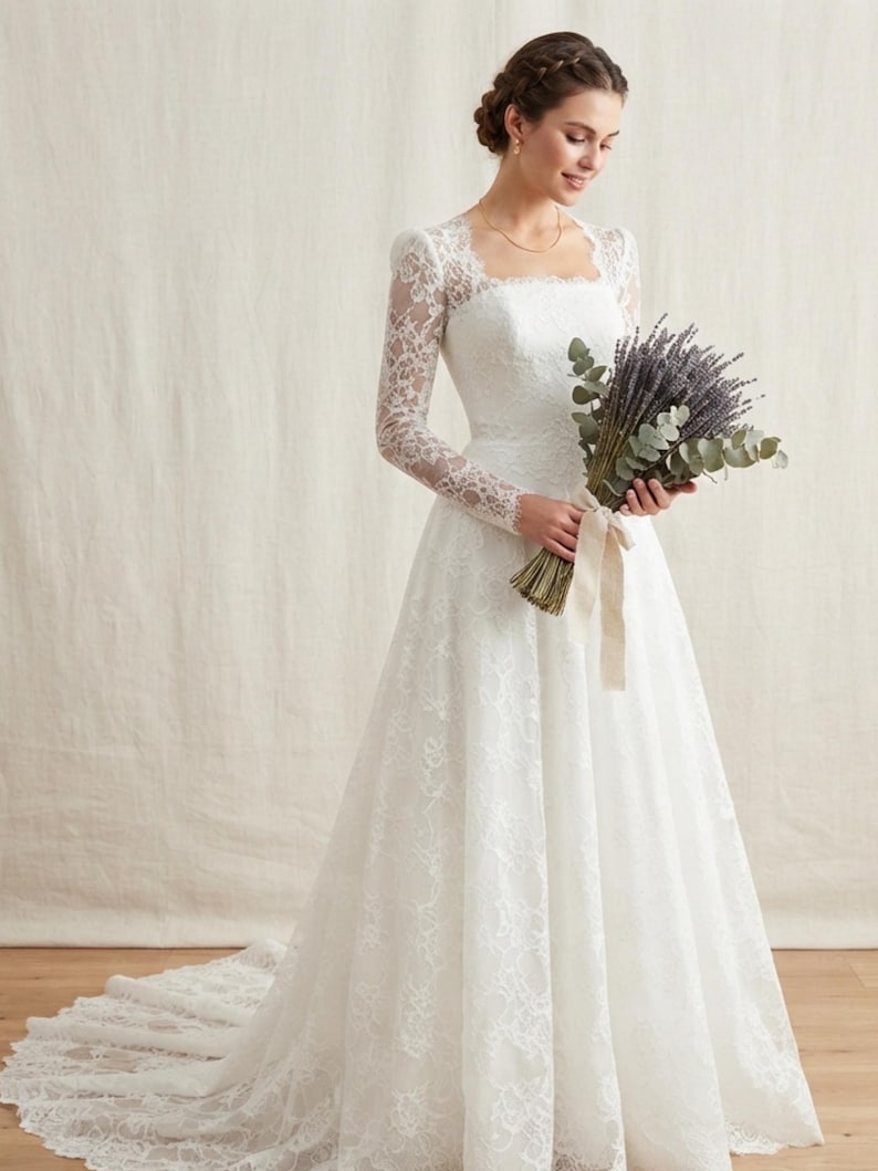 May include: A floor-length white wedding dress featuring long lace sleeves, a square neckline, and a fitted bodice that transitions into a full skirt with a train. The dress is adorned with intricate floral lace patterns throughout the fabric.