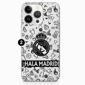 May include: Clear phone case with a black and white doodle pattern. The design includes soccer balls, crowns, and the Real Madrid logo. The phrase "&iexcl;Hala Madrid!" is printed in black on a white banner.