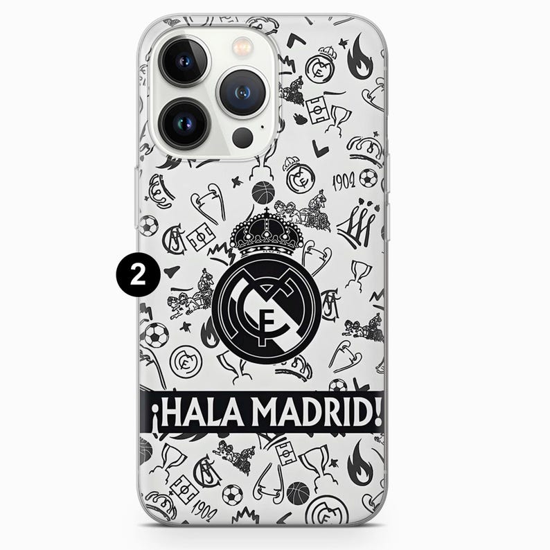 May include: Clear phone case with a black and white doodle pattern. The design includes soccer balls, crowns, and the Real Madrid logo. The phrase "&iexcl;Hala Madrid!" is printed in black on a white banner.