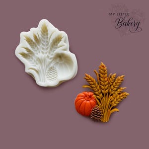 May include: A white silicone mold featuring a harvest design with wheat stalks, a pumpkin, and a pinecone, alongside a finished orange pumpkin, brown pinecone, and golden-yellow wheat stalks casting. The text My Little Bakery is visible.
