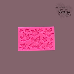 May include: Pink silicone mold with 12 leaf shapes. The mold is designed for baking and decorating cakes and other desserts.