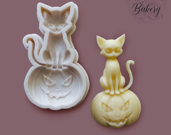 May include: A translucent silicone mold and a finished pale yellow resin casting, both depicting a cat sitting atop a jack-o'-lantern pumpkin. The mold features the text My Little Bakery in the upper right corner, with intricate details.
