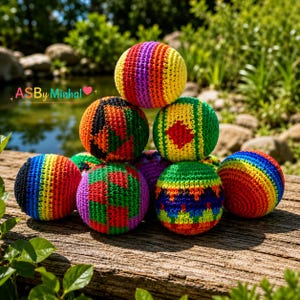 May include: A collection of nine spherical crochet balls featuring vibrant, multi-colored yarn patterns including stripes, geometric shapes, and solid color blocks. The text ASBy Minhal with a pink heart is visible in the upper left corner.