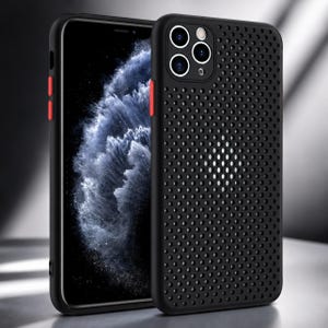 May include: A black smartphone case featuring a perforated dot pattern across the back panel. The case includes a cutout for a triple-lens camera system and has bright red physical buttons on the side, providing a contrast to the matte black finish.