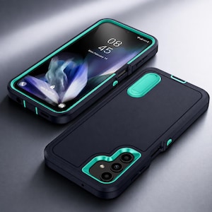 Peut inclure: Une coque de protection pour smartphone noire et bleu sarcelle, présentée de face et de dos. La vue de face montre un écran de téléphone affichant l'heure 08:45 et la date Mon, February 14. Le dos présente une découpe pour l'appareil photo.