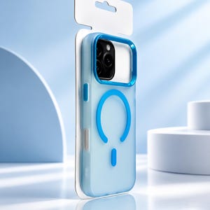 May include: A translucent light blue smartphone case with a darker blue camera frame and a circular magnetic charging ring on the back. The case is mounted on a white cardboard retail display card with a cutout at the top for hanging on a rack.