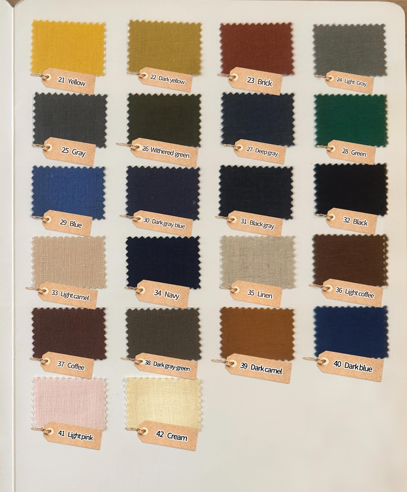 May include: A color swatch chart featuring twenty-two rectangular fabric samples with pinked edges. Each sample is labeled with a numbered tan tag, including colors like yellow, brick, gray, green, blue, navy, coffee, light pink, and cream.
