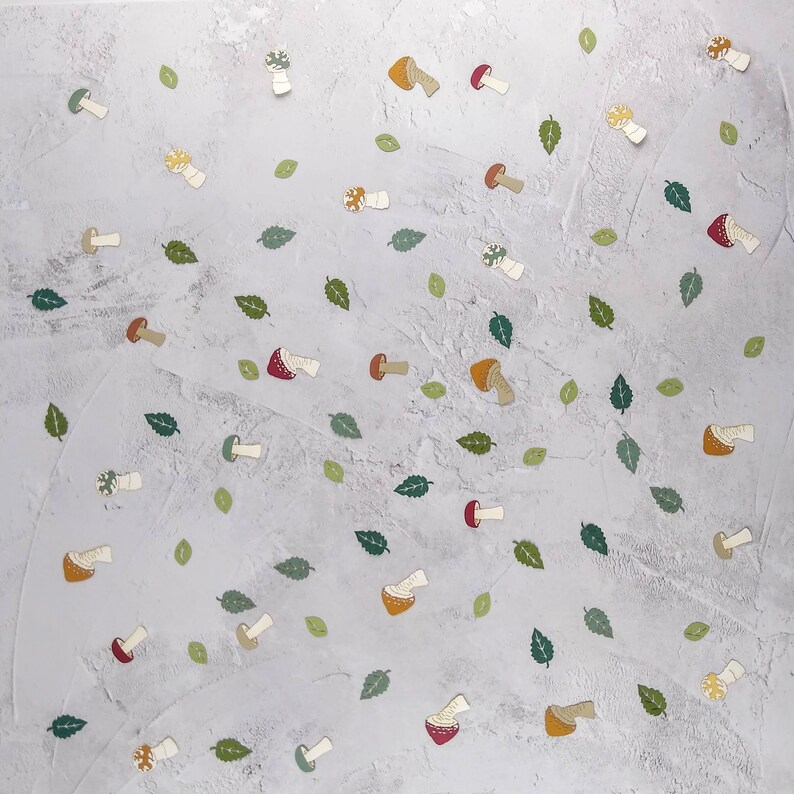 May include: A white background with a scattered pattern of green leaves and various colored mushrooms. The mushrooms are in different shapes and sizes, with some having red, yellow, or brown caps.