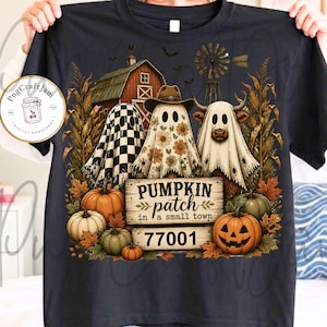 May include: A black short-sleeve t-shirt featuring a graphic of three ghosts, a barn, a windmill, and pumpkins. The text reads PUMPKIN patch in a small town 77001. The design includes a checkered ghost, a floral ghost, and a highland cow ghost.