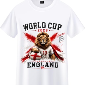 May include: A white t-shirt featuring a graphic of a lion wearing a jersey with the number 10, holding a football with an England flag design. The text reads WORLD CUP 2026, ENGLAND PRIDE PASSION GLORY, and CHAMPION ENGLAND with a red cross.