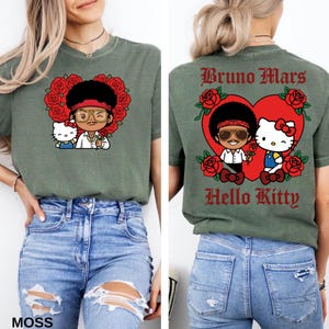 May include: Moss green t-shirt featuring a cartoon illustration of a character with sunglasses and Hello Kitty, surrounded by red roses. The back of the shirt has the text "Bruno Mars Hello Kitty" in a heart shape.