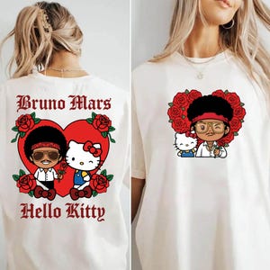 May include: Off-white t-shirt featuring a cartoon illustration of Bruno Mars and Hello Kitty inside a red heart surrounded by red roses. The text "Bruno Mars" and "Hello Kitty" are printed in a gothic font.
