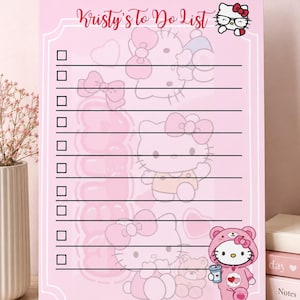 May include: A light pink rectangular to-do list notepad featuring the text Kristy's To Do List at the top. The page includes ten horizontal lines with checkboxes and faint illustrations of a white cat character wearing bows and a bear costume.