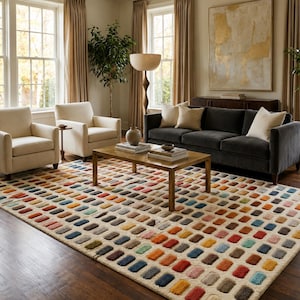 May include: A rectangular area rug featuring a repeating grid pattern of small, rounded rectangular tufts in various colours including red, blue, yellow, green, and brown, set against a light cream-coloured background with a textured pile.