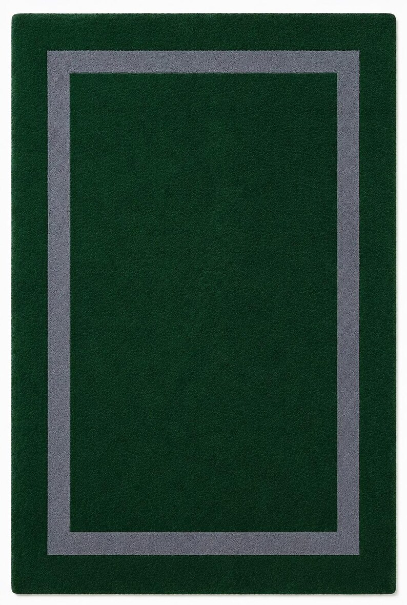 May include: A rectangular area rug featuring a deep forest green field with a solid, medium gray border frame set inward from the outer edge. The rug has a uniform, short-pile texture throughout, creating a clean, geometric design with sharp corners.