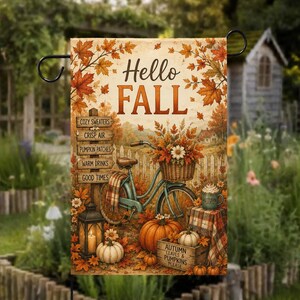 Peut inclure: Un drapeau de jardin rectangulaire avec le texte Hello Fall, un vélo bleu sarcelle avec un panier de fleurs d'automne, un panneau en bois avec des phrases saisonnières, des citrouilles, une lanterne et une caisse marquée Autumn Leaves & Pumpkins.