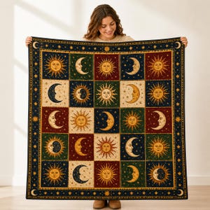 May include: A square quilt featuring a grid of alternating sun and moon illustrations in shades of deep blue, forest green, and dark red. The border is decorated with small stars and crescent moons on a dark blue background.