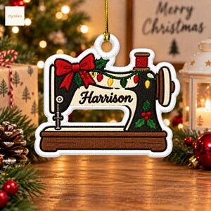May include: A white-bordered, embroidered Christmas ornament shaped like a vintage sewing machine. The machine is black and cream with a red bow, green holly leaves, and a string of colourful Christmas lights. The name Harrison is stitched in black.