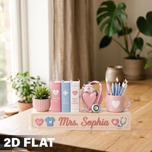 May include: A wooden desk organizer featuring the name Mrs. Sophia in pink script. It includes three book-shaped blocks, a pink planter with a small green plant, a pink mug holding pens, and a heart-shaped decoration with a stethoscope and nurse cap.