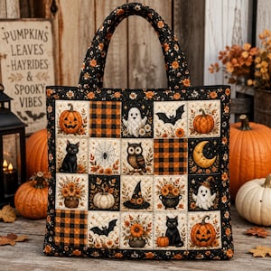 May include: A quilted tote bag featuring a grid of squares with Halloween-themed illustrations including jack-o'-lanterns, ghosts, black cats, an owl, a witch hat, a cauldron, bats, a spider web, a crescent moon, and orange and black buffalo plaid.