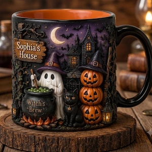 May include: A black ceramic mug with an orange interior featuring a 3D-style Halloween scene. It depicts a ghost in a purple hat stirring a cauldron labeled Witch's Brew, a black cat, stacked pumpkins, and a sign reading Sophia's House.
