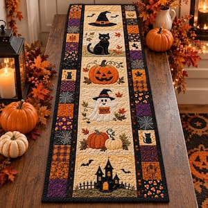 May include: A rectangular quilted table runner featuring a central vertical panel with Halloween motifs including a witch hat, black cat, jack-o'-lantern, ghost holding a sign that says BOO!, pumpkins, and a haunted house, bordered by patchwork squares.