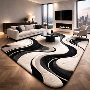 Op de afbeelding: Een groot rechthoekig vloerkleed met een contrastrijk abstract ontwerp met vloeiende, gebogen banen in tinten crème, antracietgrijs en effen zwart. Het kleed heeft een getextureerde, meerlaagse pool die een driedimensionaal effect creëert.