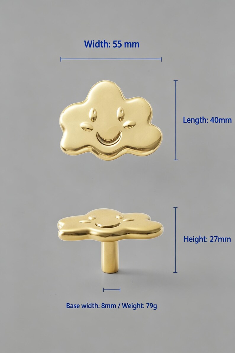 May include: A gold-colored cloud-shaped cabinet knob with a smiling face. The knob has a width of 55 mm, a length of 40 mm, a height of 27 mm, a base width of 8 mm, and a weight of 79 g. The surface is smooth and reflective with a metallic finish.