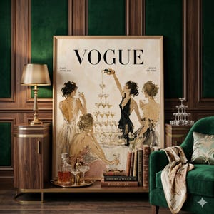 May include: A framed Vogue magazine cover art print with a champagne tower and figures in evening wear. The print has a vintage aesthetic, with the Vogue logo at the top. The scene is set in a room with a green velvet chair and a gold lamp.
