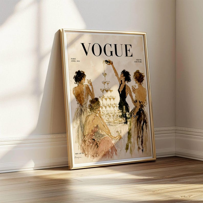 May include: A framed print of a Vogue magazine cover. The illustration shows women in gowns around a champagne tower. The gold frame enhances the vintage feel. The word "VOGUE" is at the top of the print.