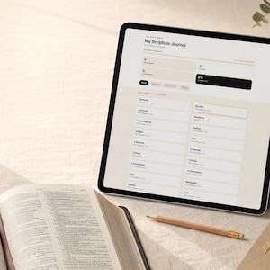 May include: A tablet displaying a digital My Scripture Journal interface with a list of Old Testament books, positioned next to an open physical Bible and a wooden pencil. The screen shows progress tracking metrics and a clean, light-toned layout.