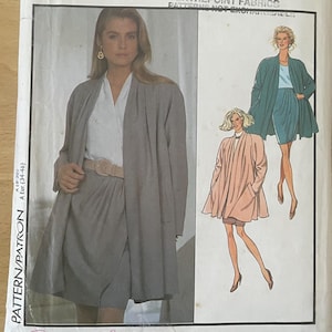 May include: A vintage sewing pattern titled "Style" with the number 1958. The pattern features a woman in a gray outfit and two illustrations of similar outfits. The size is A (8-20).