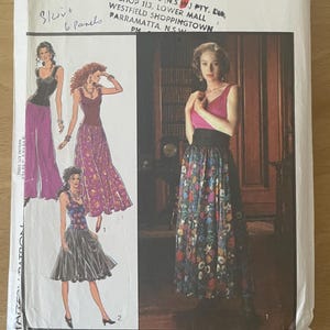 May include: A vintage sewing pattern titled "Style 1654" featuring illustrations of women's skirts and tops. The pattern packet is white with red and black text, and includes sizing information. The image shows a variety of skirt styles.